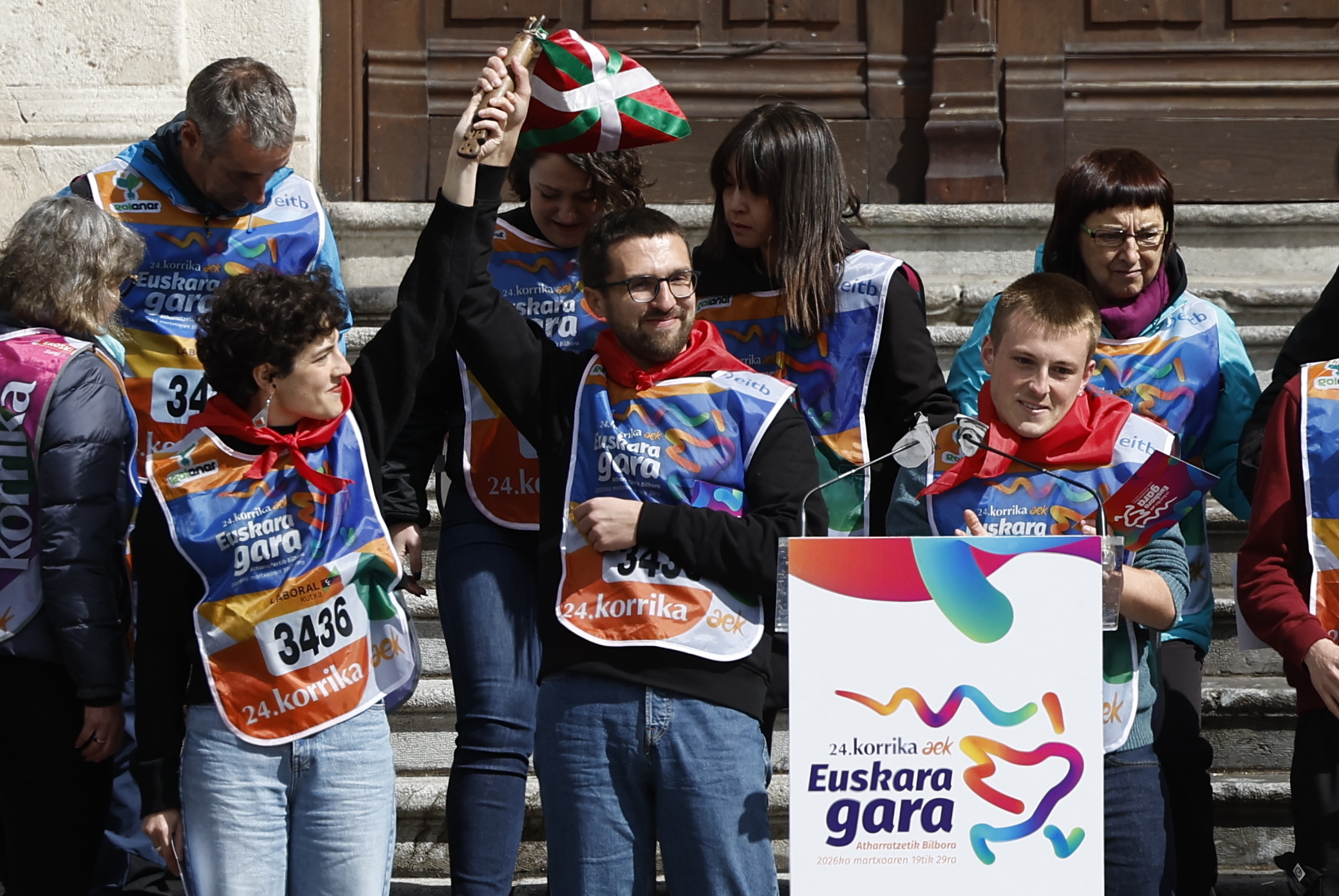 Oier Gil de San Vicente Pla aplaude mientras dos de sus compañeros levantan el testigo con la ikurriña ayer en las escalinatas del Ayuntamiento de Bilbao.