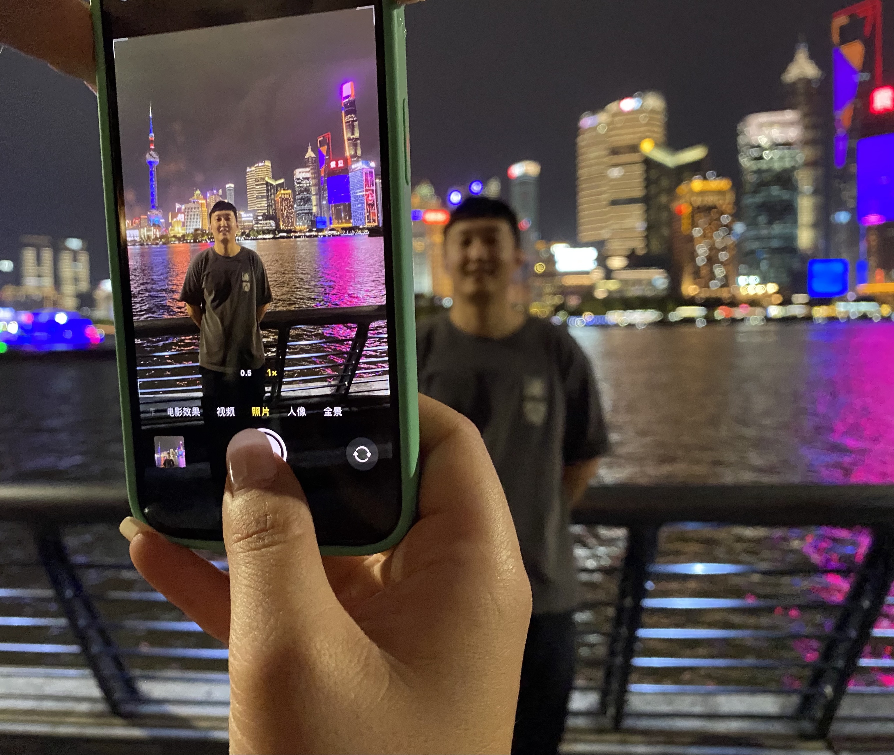 Un turista posando frente a los rascacielos de Shanghai.