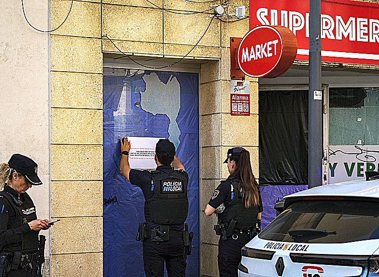La Policía Local de Ibiza precintando el antiguo supermercado.