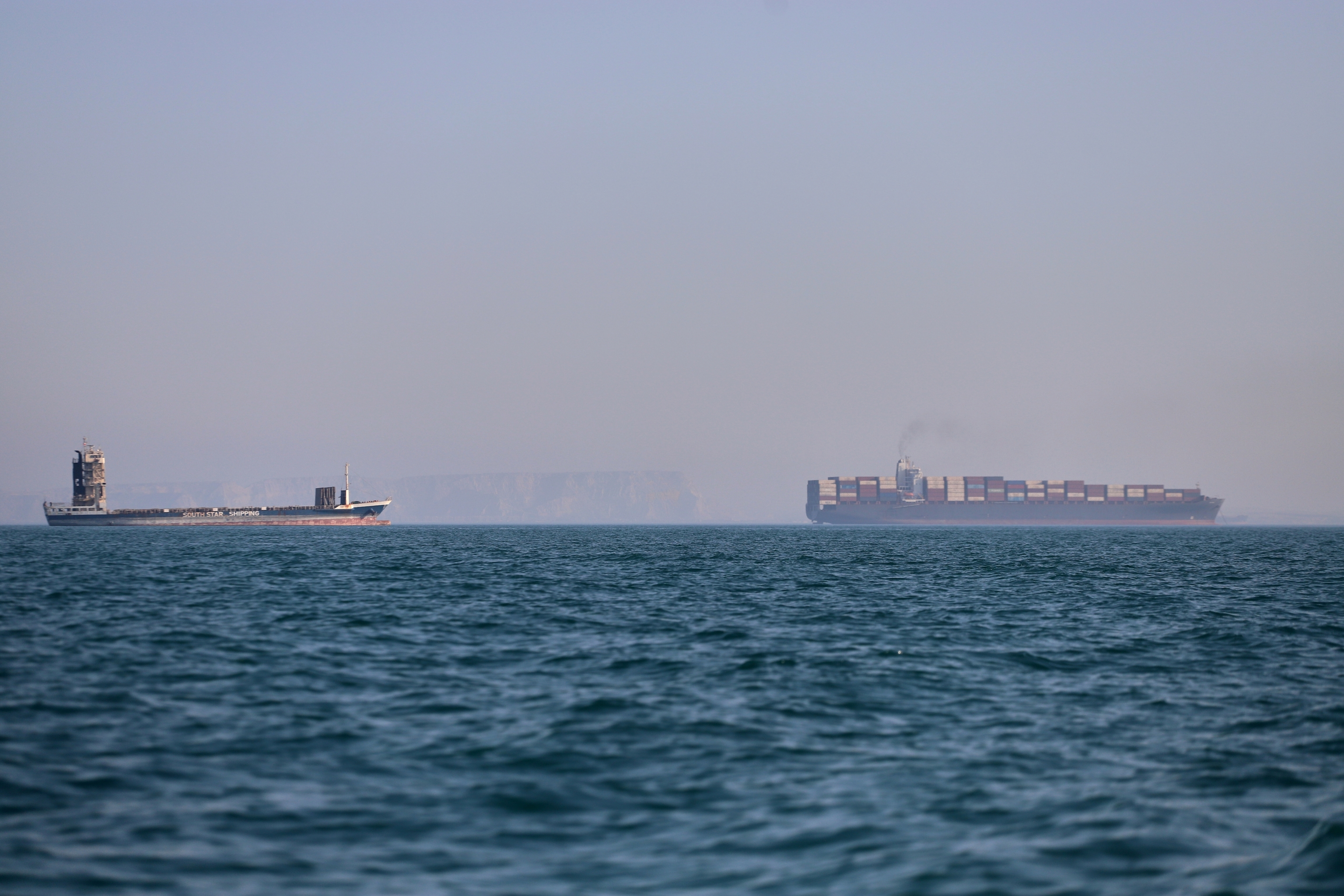 Un buque portacontenedores y otro barco de carga, en el Estrecho de Ormuz, el miércoles, frente a Bandar Abbas, Irán.