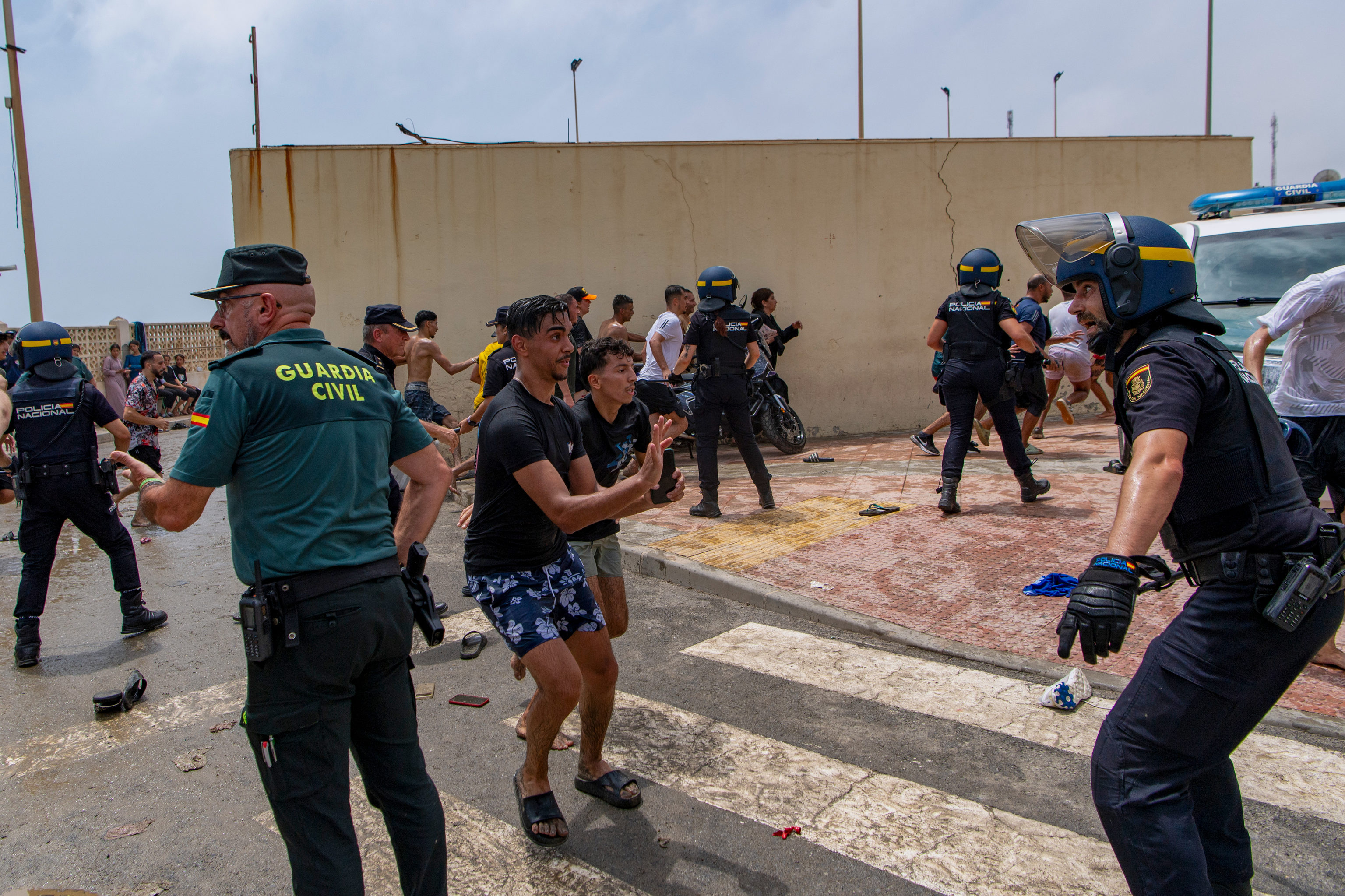 Agentes de las Fuerzas de Seguridad tratan de contener a los migrantes.