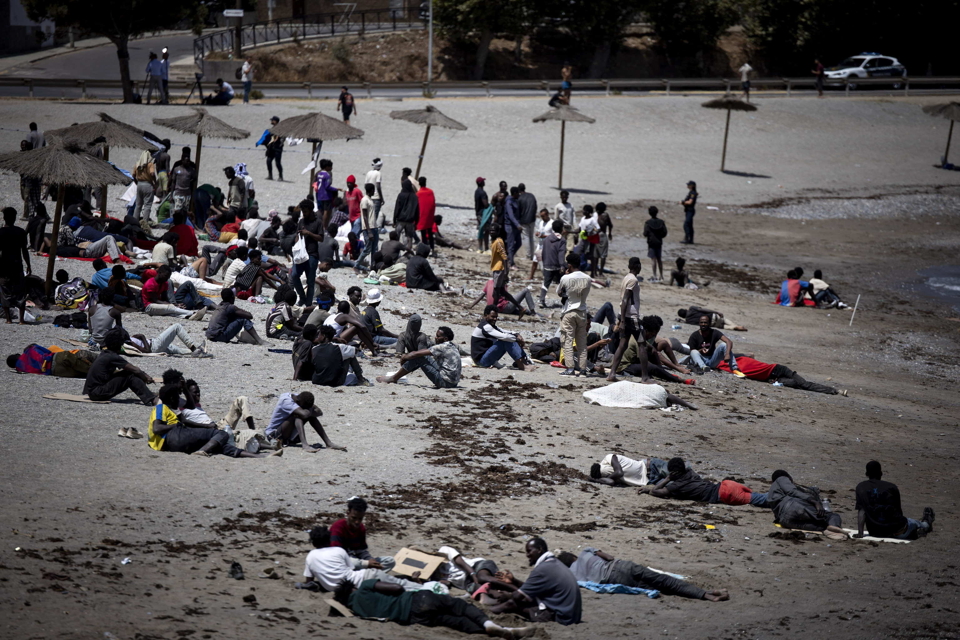 Inmigrantes subsaharianos descansan en la playa del Trampol�n, en Ceuta.