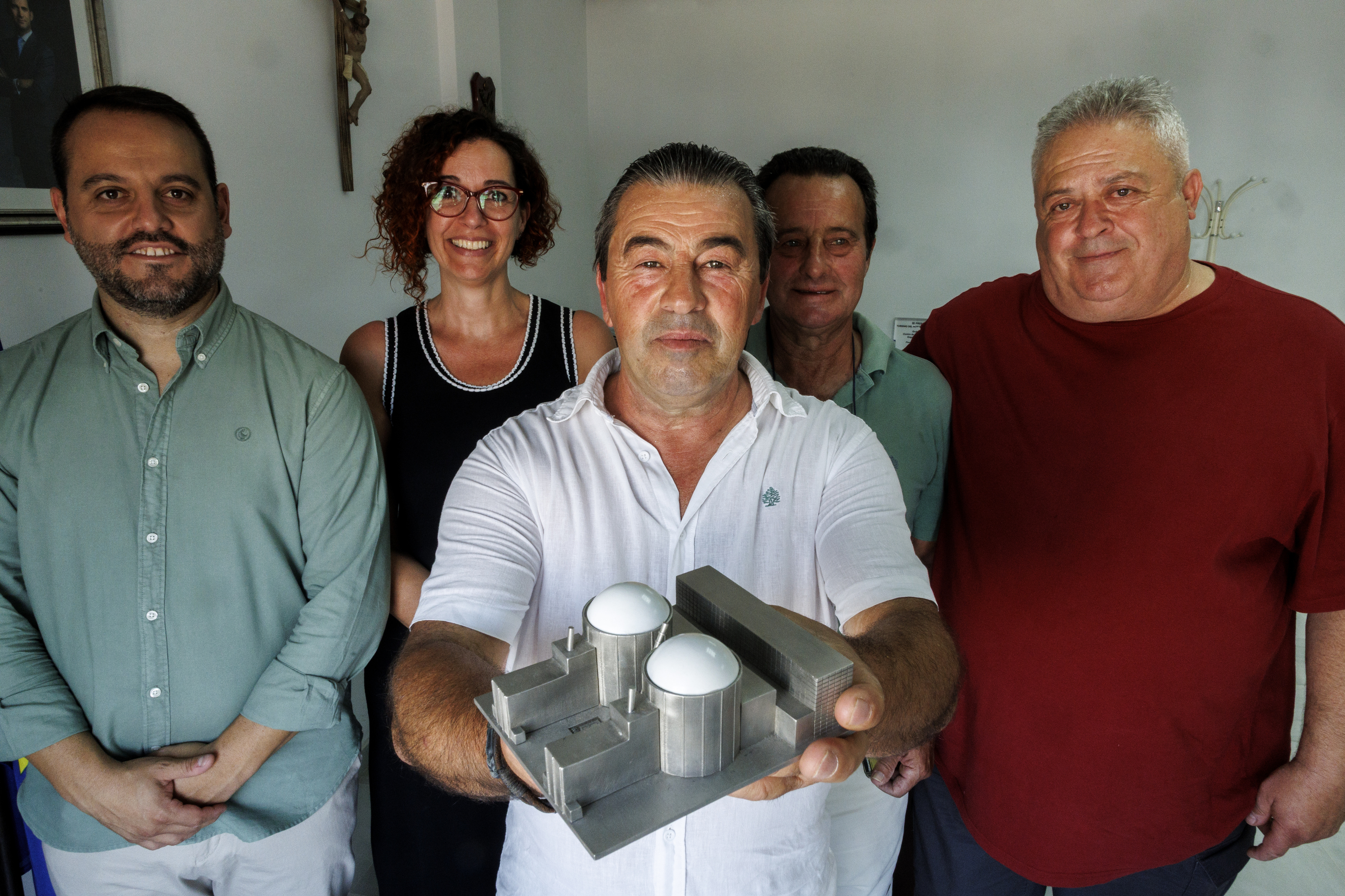 El alcalde de Almaraz sostiene una maqueta de la central nuclear junto a otros ediles de la zona.