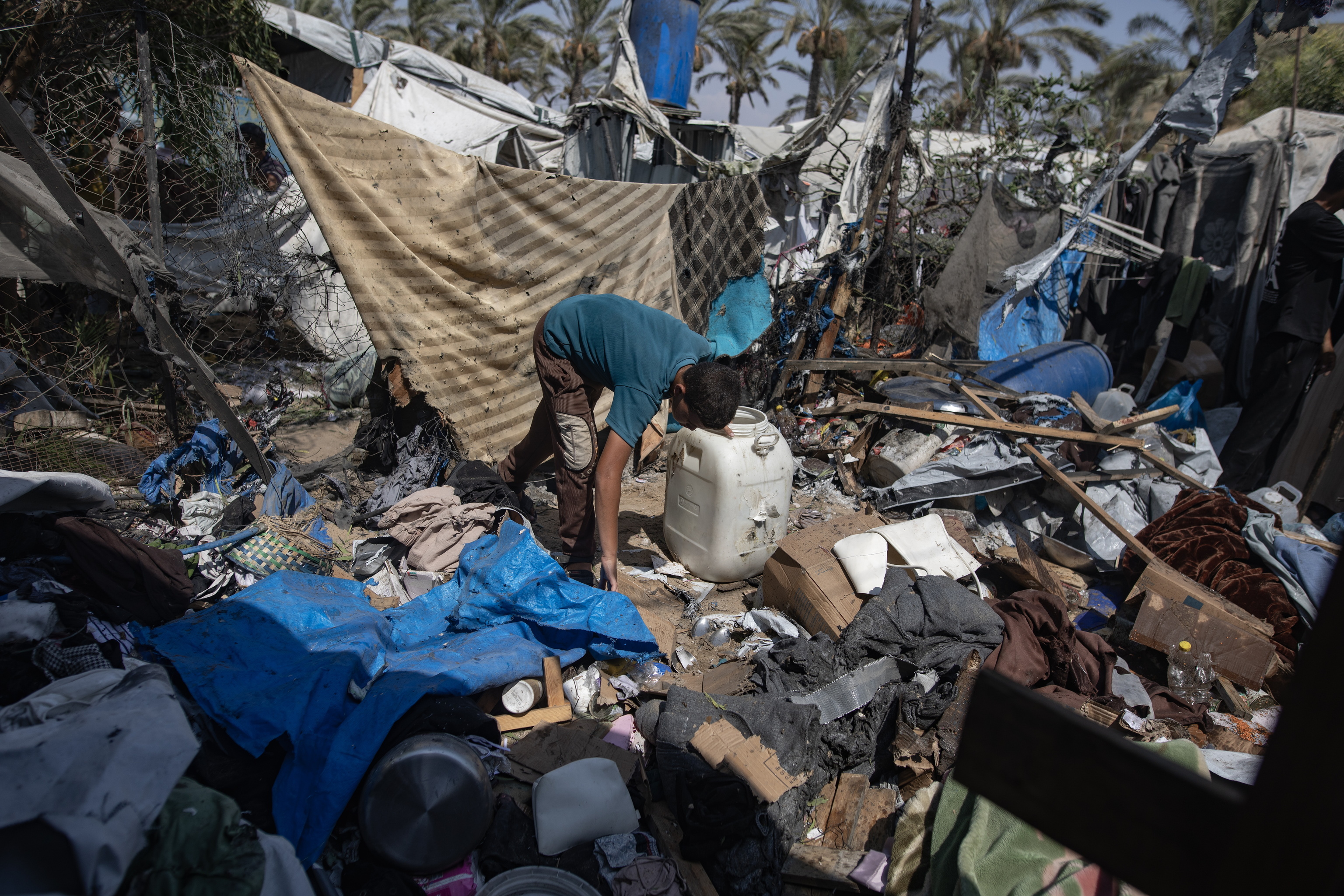 Un palestino revisa los restos de una tienda bombardeada en Jan Yunís.