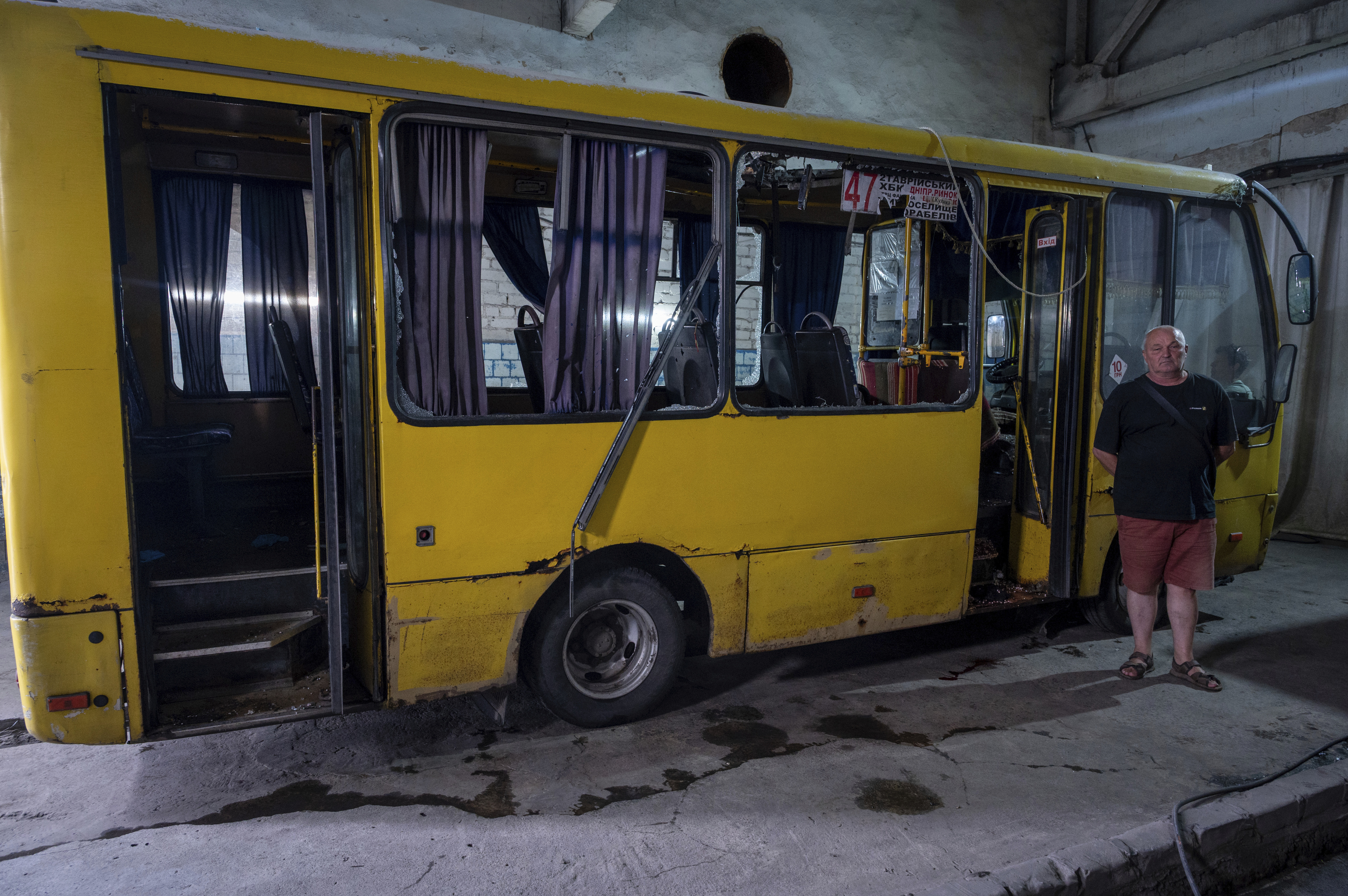 Oleg Kuznienko posa junto al autobús que conducía cuando fue alcanzado por un UAV ruso.
