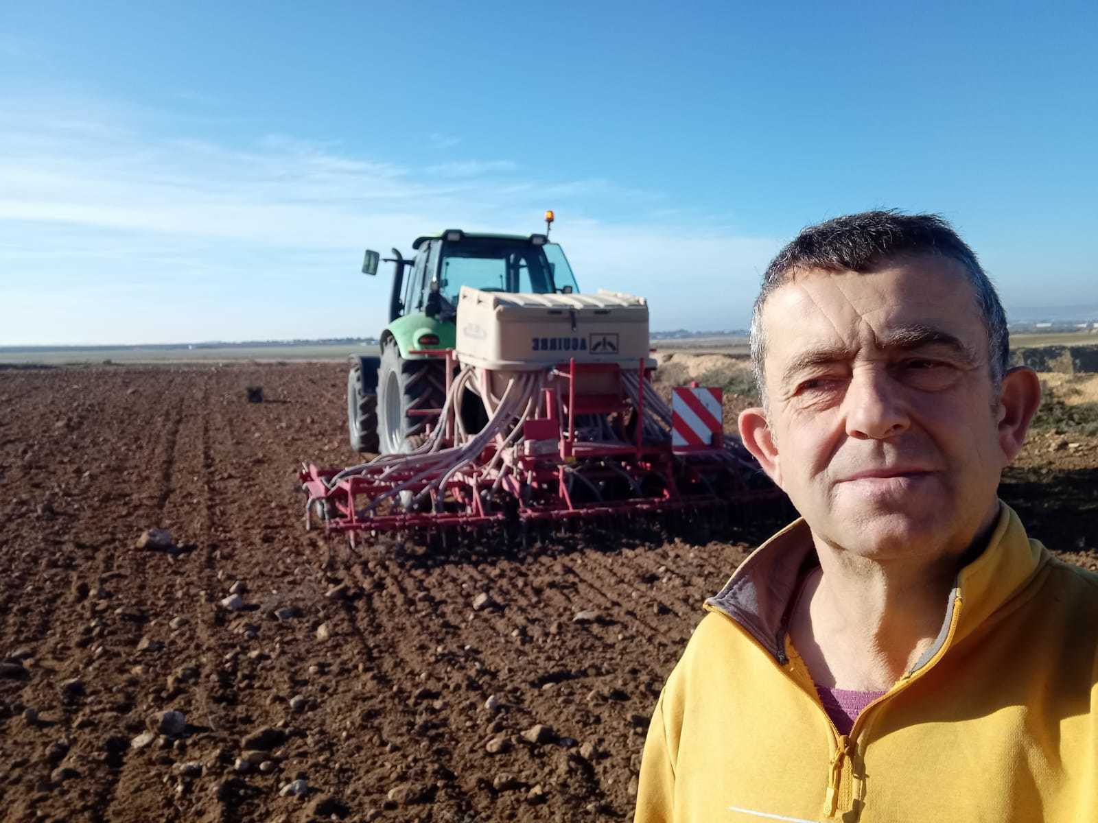 Javier Fatás, agricultor afectado, junto a un tractor
